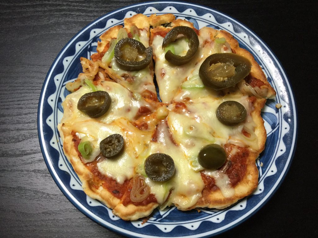 Quick and easy frying pan pizza topped with anchovies, green onions, and pickled jalapeños