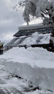 Snow sliding off a roof of a building in Minamiuonuma, Niigata, Japan
